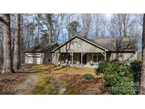 Charming home features a covered front porch, stone accents, and a detached garage at 4530 Meandering Way, Conover, NC 28613