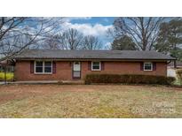 Charming single-story brick home featuring a cozy front porch and manicured landscaping at 906 16Th Nw St, Conover, NC 28613