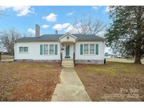 Charming white house with a spacious yard and walkway at 913 S Franklin St, China Grove, NC 28023