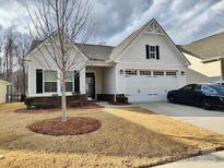 Craftsman style home with white siding, two-car garage, and landscaped lawn at 10356 Black Locust Ln, Harrisburg, NC 28215