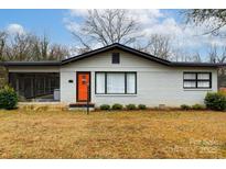 Charming ranch home with a bright orange door and well-manicured lawn at 1223 India Hook Rd, Rock Hill, SC 29732