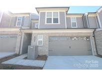 Modern two-story townhome with attached garage and neutral colors at 1819 Teachers House Nw Rd, Concord, NC 28027