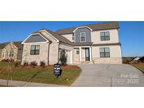 Charming two-story home boasts stone accents, neutral siding, and a well-manicured front yard at 1852 Yardley St, Rock Hill, SC 29732