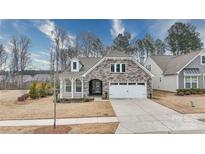 Charming craftsman style home with stone accents and a two-car garage at 201 Picasso Trl, Mount Holly, NC 28120