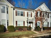 Two-story townhome with brick and siding exterior, balcony, and landscaping at 2711 Thornbush Ct, Charlotte, NC 28270