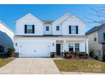 Two-story white house with black shutters, two-car garage, and landscaping at 3962 Isenhour Rd, Kannapolis, NC 28081