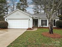 Ranch home with attached garage and landscaped lawn at 4211 Suttle Pl, Matthews, NC 28104