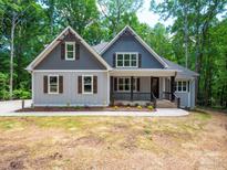Charming craftsman home with gray siding, wooden shutters, and a welcoming front porch at 4607 Ferguson Cir, Waxhaw, NC 28173