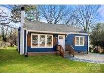 Charming blue house with white accents and wood shutters at 529 Ambassador St, Charlotte, NC 28208