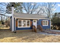 Charming blue house with white accents and wooden shutters at 529 Ambassador St, Charlotte, NC 28208