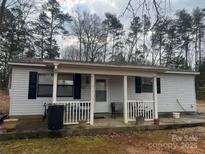 Charming single-story home featuring a cozy porch and a well-maintained front yard at 5500 Olivet Dr, Charlotte, NC 28227