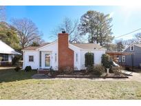 White house with brick chimney, landscaping, and carport at 617 York S Ave, Rock Hill, SC 29730