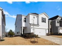 Two-story house with white siding, attached garage, and landscaping at 642 Citriadora St, Fort Mill, SC 29715