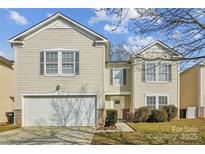 Two-story house with beige vinyl siding, a white garage door, and landscaping at 2010 Durand Rd, Fort Mill, SC 29715