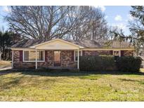 Brick ranch house with a covered porch and large yard at 214 Costner Dr, Bessemer City, NC 28016