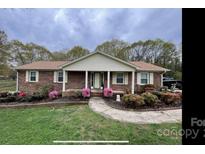 Brick ranch house with landscaping and a walkway at 3333 Audrey Dr, Gastonia, NC 28054