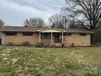 Charming brick home featuring a covered front porch and a spacious front yard at 48780 N Us 52 Hwy, Richfield, NC 28137