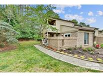 Brick townhouse exterior with landscaping and walkway at 8049 Charter Oak Ln, Charlotte, NC 28226