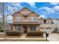 Charming two-story home featuring a welcoming front porch and well-manicured landscaping at 11138 Skytop Dr, Huntersville, NC 28078