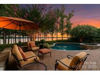 Scenic pool with mature trees and lake views; perfect for relaxation and outdoor enjoyment in a peaceful setting at 155 Union Chapel Dr, Mooresville, NC 28117