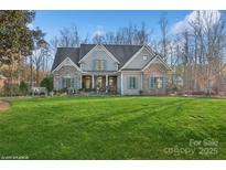 Charming two-story home features a landscaped yard, stone accents, and inviting curb appeal at 1813 Wedowee Ct, Rock Hill, SC 29732