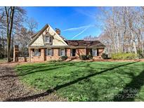 Brick ranch house with a large front yard and mature trees at 3729 Carmel Acres Dr, Charlotte, NC 28226