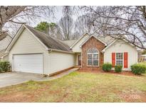 Charming single-story home featuring a brick accent, attached garage, and well-maintained lawn at 4648 Madeline Dr, Rock Hill, SC 29732