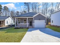 Gray exterior home with white garage door and brick accents at 5618 Pine St, Charlotte, NC 28269
