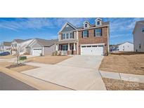 Charming home with a two-car garage, driveway, brick and vinyl siding at 7324 Teague Dr, Gastonia, NC 28056