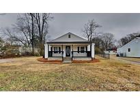 Charming white cottage with a front porch and well-maintained lawn at 105 Valley Ave, Clover, SC 29710