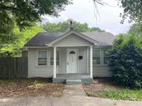 Charming single-story home with a covered front porch, white columns, and a well-maintained front yard at 1404 Linwood Rd, Gastonia, NC 28052
