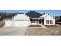 Charming single-story home featuring a two-car garage, light brick accents, and a covered front porch at 174 Swann Rd # 3, Statesville, NC 28625