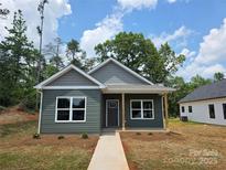Charming new construction home featuring a modern gray exterior, welcoming entrance, and inviting curb appeal at 211 Benfield Rd, Kings Mountain, NC 28086