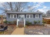 Gray house with white trim, steps, landscaping, and a walkway at 225 Spencer St, Rock Hill, SC 29730