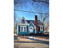 Charming teal home with a gabled roof and manicured lawn at 225 Wilson St, Albemarle, NC 28001