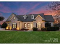 Brick house with landscaped lawn, at dusk at 498 New Salem Rd, Statesville, NC 28625