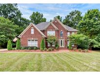 Brick home with a landscaped lawn and driveway at 508 Cobbs Glen Ct, Rock Hill, SC 29732