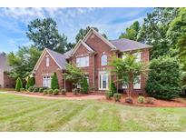 Brick house with 2-car garage, manicured lawn, and mature trees at 508 Cobbs Glen Ct, Rock Hill, SC 29732