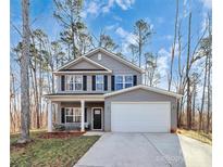 Two-story house with gray siding, a white garage door, and a covered front porch at 5510 Brickstone Dr, Charlotte, NC 28227