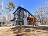 Modern barn-style home with large windows and covered porch at 5700 Mcwhorter Rd, Waxhaw, NC 28173