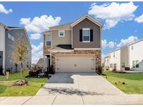 Charming two-story home with a two-car garage and a combination of stone and siding exterior at 571 Palmarosa St # 130, Fort Mill, SC 29715