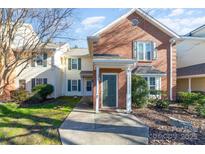 Brick front exterior of charming townhome with landscaping at 9427 S Vicksburg Park Ct, Charlotte, NC 28210