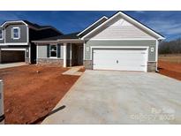 Charming single-Gathering home showcasing stone accents, neutral paint, and a two-car garage on a sunny day at 1012 Farm Branch Ct, Indian Trail, NC 28079