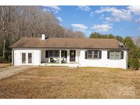 White ranch house with attached garage and a spacious yard at 1241 Red River Rd, Rock Hill, SC 29730