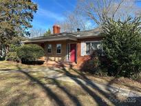 Brick ranch house with red door, walkway, and landscaping at 147 W Mcneely Ave, Mooresville, NC 28115