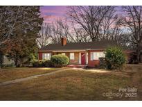 Brick house with red door, walkway, and landscaping at 147 W Mcneely Ave, Mooresville, NC 28115