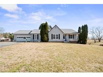 Ranch style home with gray metal roof, attached garage, and manicured lawn at 2356 Ben Yount Ln, Vale, NC 28168