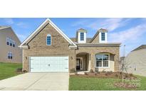 Brick two-story house with a white two-car garage and landscaped lawn at 4474 Doyle Ridge Rd, Maiden, NC 28650