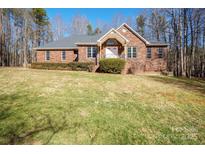 Brick ranch house with a large yard and attached garage at 6238 Mountain Vine Ave, Kannapolis, NC 28081