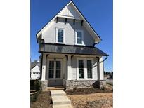 Two-story craftsman home with gray siding, black metal roof, and stone accents at 718 Barrel Aly, Fort Mill, SC 29715